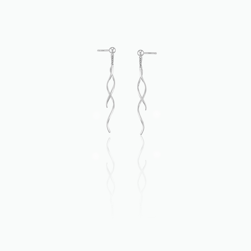 Silver earrings with wavy design on a white background