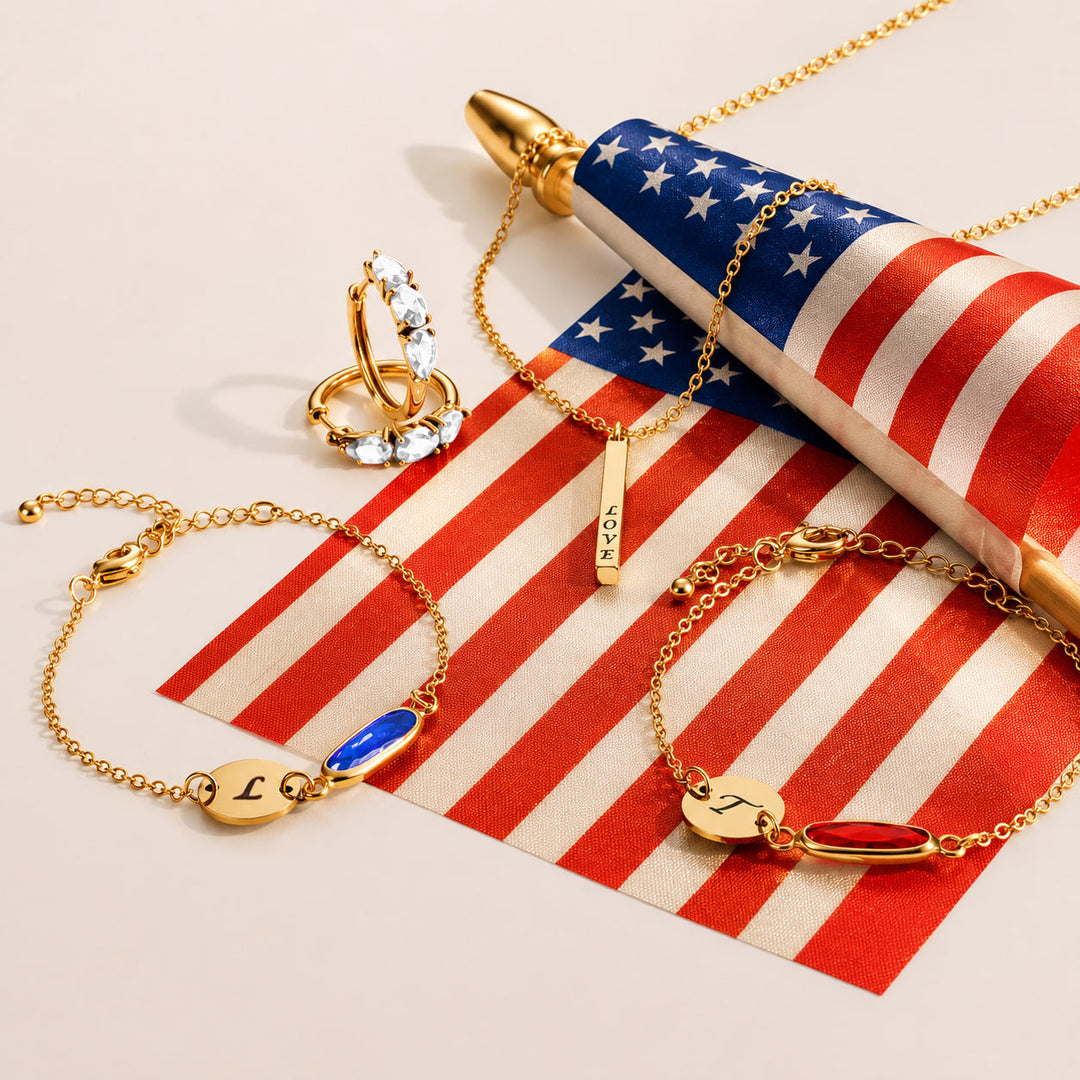personalized gold jewelry flat lay on American flag for 4th of July gifting
