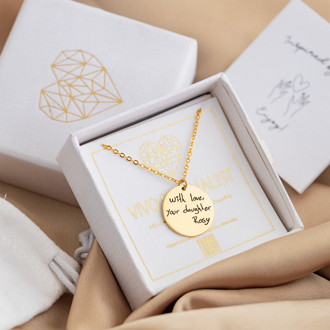 VIVO Minimalist Personalized Handwriting Disc Necklace in gold vermeil displayed in gift box with handwritten note in background engraved with the words with love your daughter Rosy