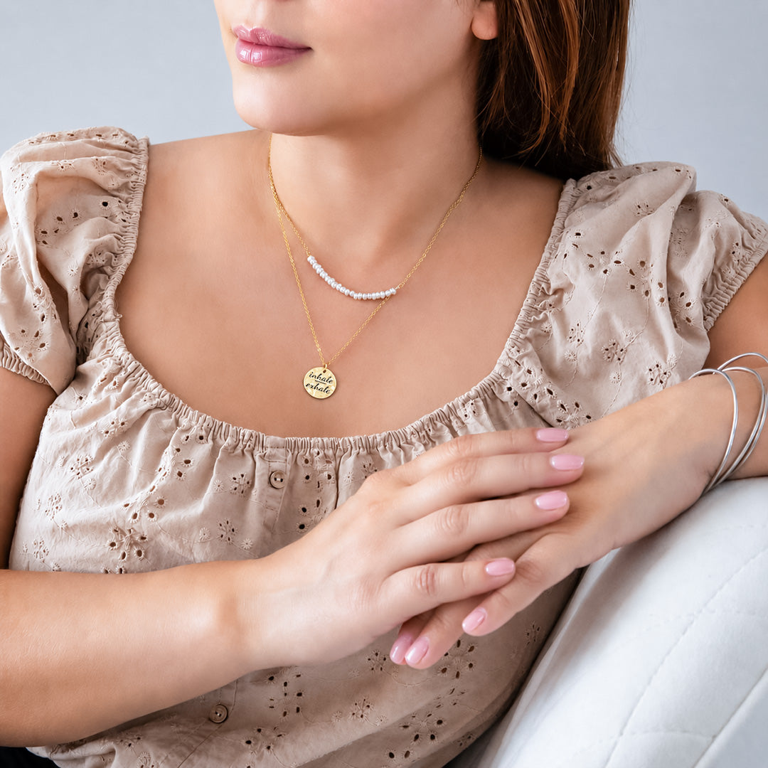Personalized hammered disc necklace layered on neck, gold finish