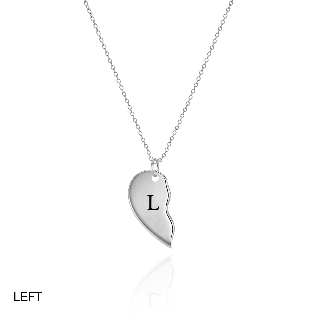 Silver-tone left half of a split heart necklace engraved L on a white background