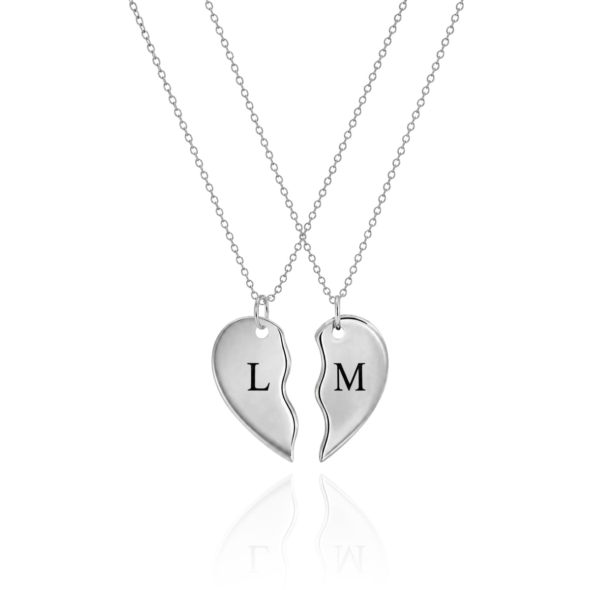 Silver-tone split heart necklaces engraved L and M on a white background