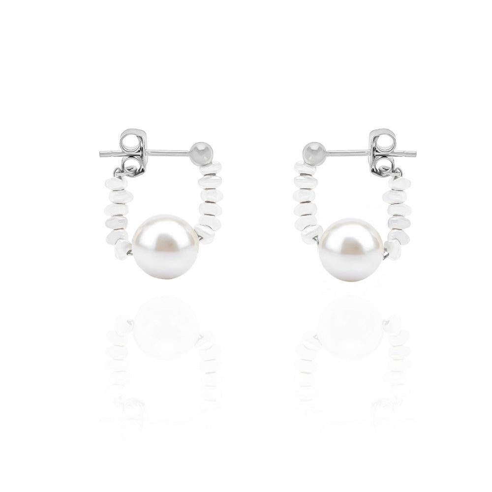 A pair of dainty pearl hoop earrings with high-polished sterling silver hoops and freshwater pearls.