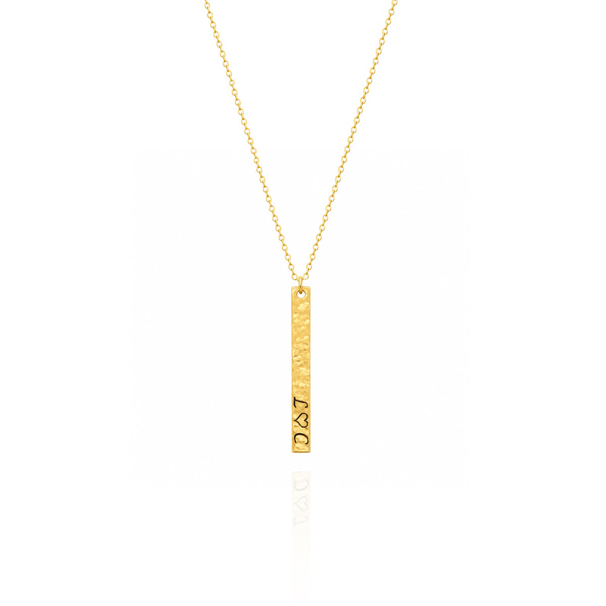 Gold-tone hammered vertical bar necklace engraved with initials and a heart symbol on a white background