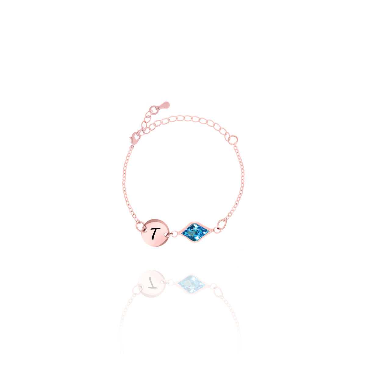 Rose-gold-tone bracelet with engraved T initial disc and blue faceted marquise-shaped stone on white background