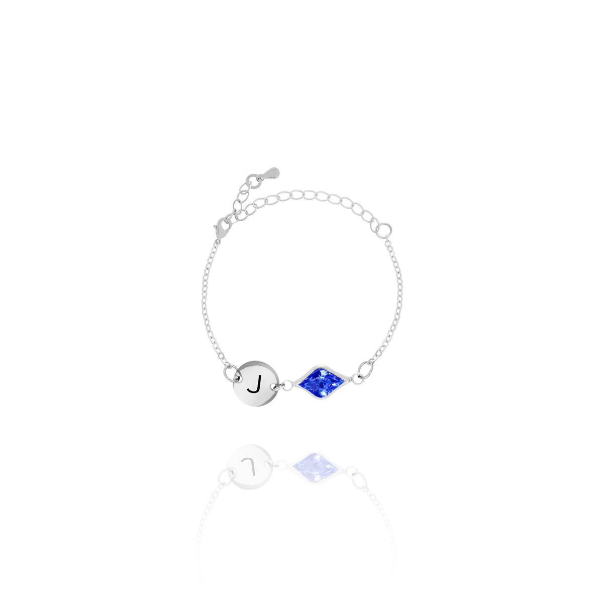 Silver-tone bracelet with engraved J initial disc and blue faceted marquise-shaped stone on white background