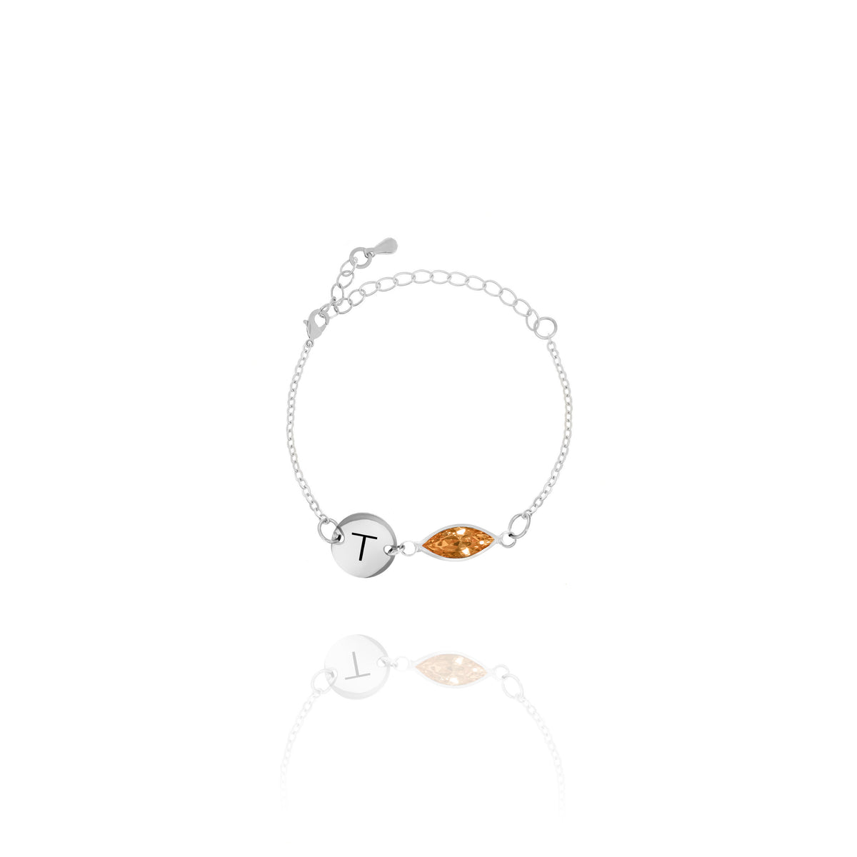 Silver-tone bracelet with engraved T initial disc and orange faceted marquise-shaped stone on white background