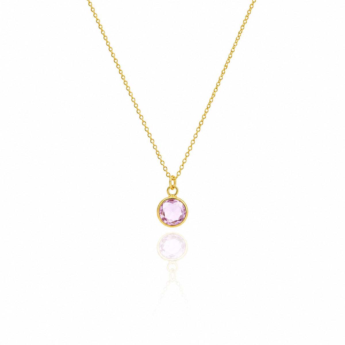 Gold-tone necklace with a round pink stone pendant displayed on a white background