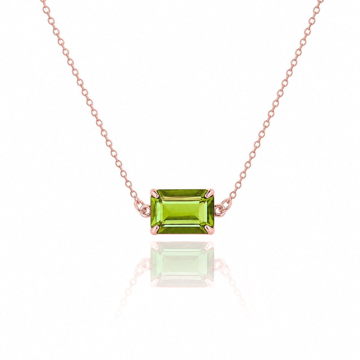 Rose-gold-tone necklace with a rectangular green faceted pendant on a white background