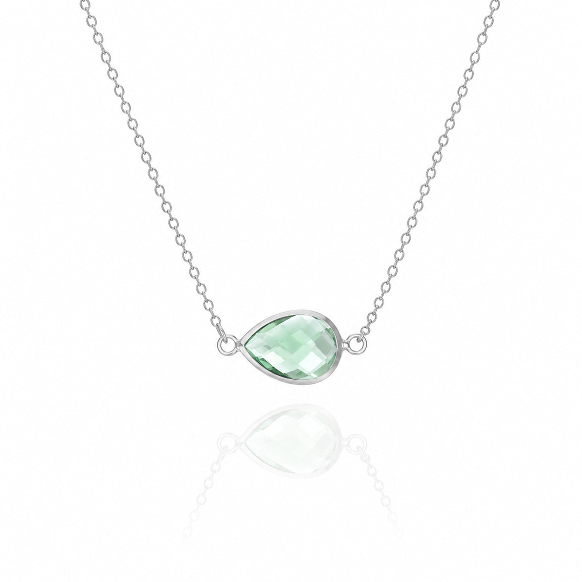 Silver-tone necklace with a light green faceted teardrop pendant on a white background
