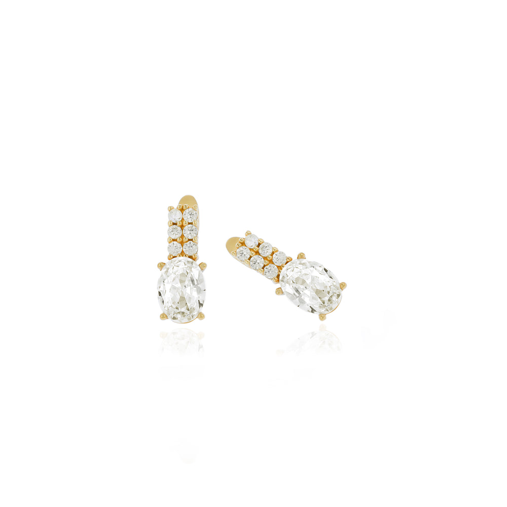 A pair of personalized sterling silver birthstone earrings with gold accents and clear gemstones.