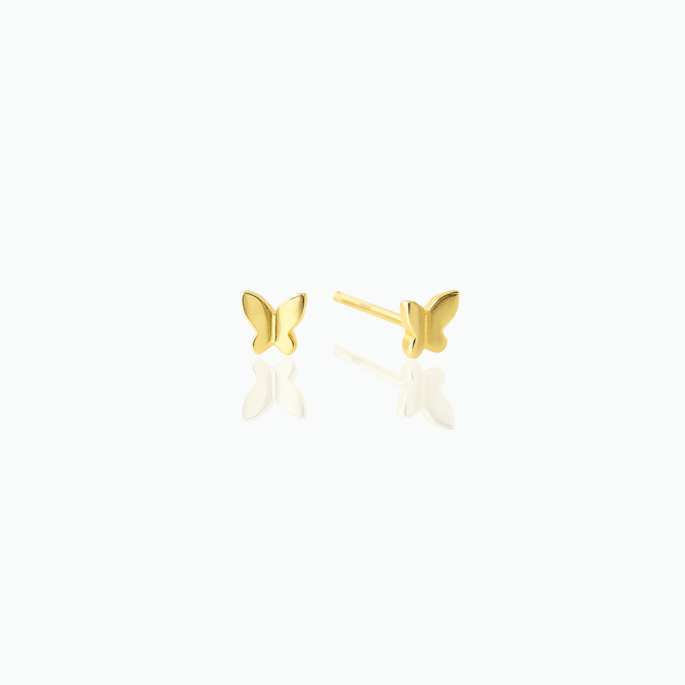 Gold butterfly earrings on a white background