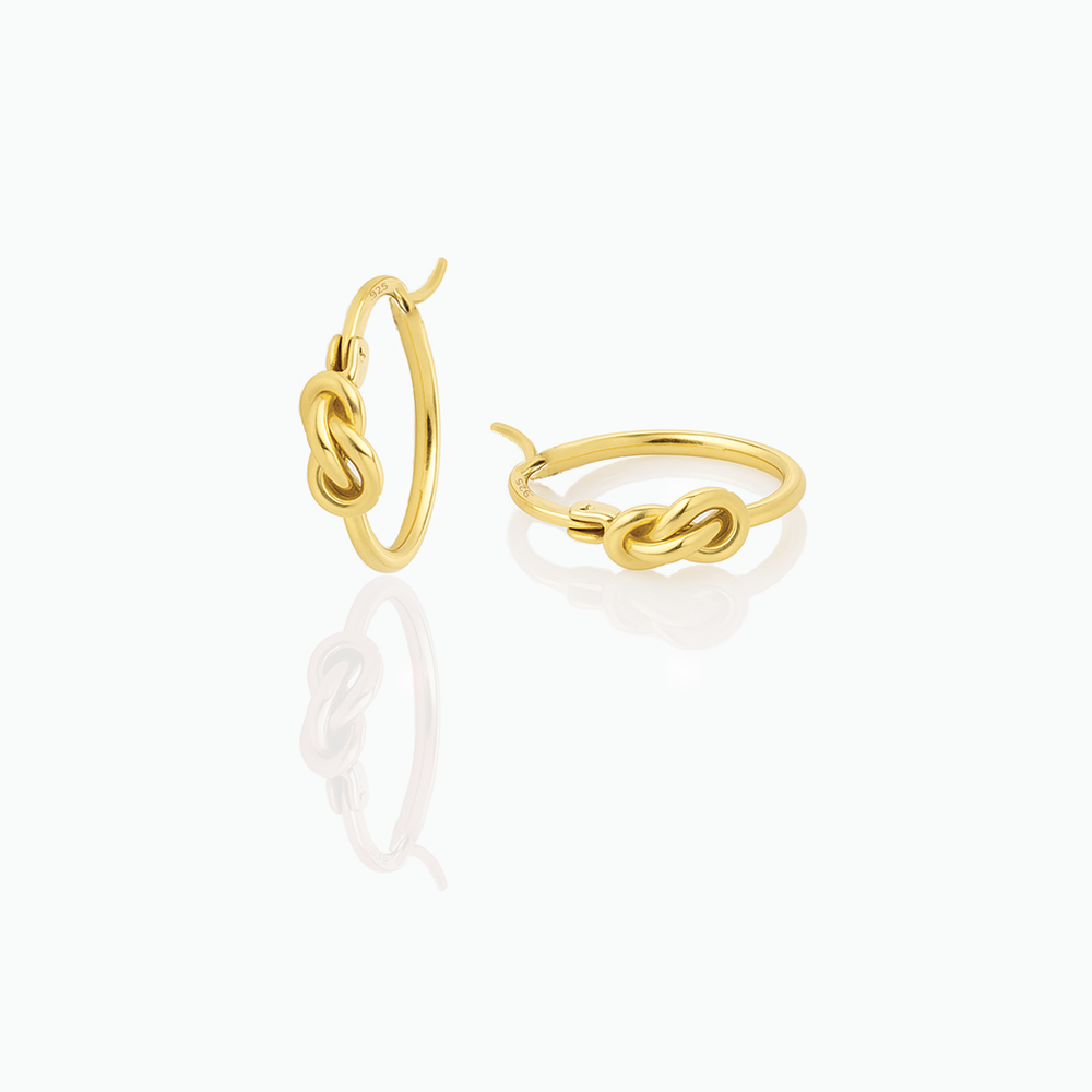 Gold hoop earrings on a white background