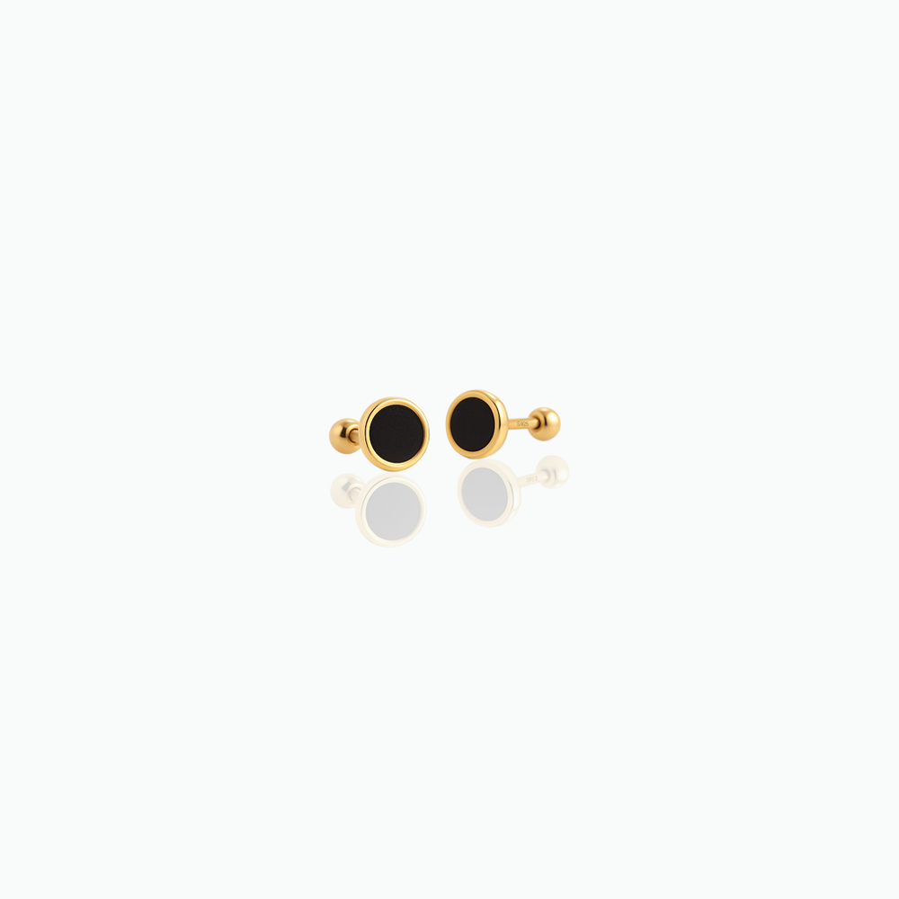 Pair of gold earrings with black stones on a white background