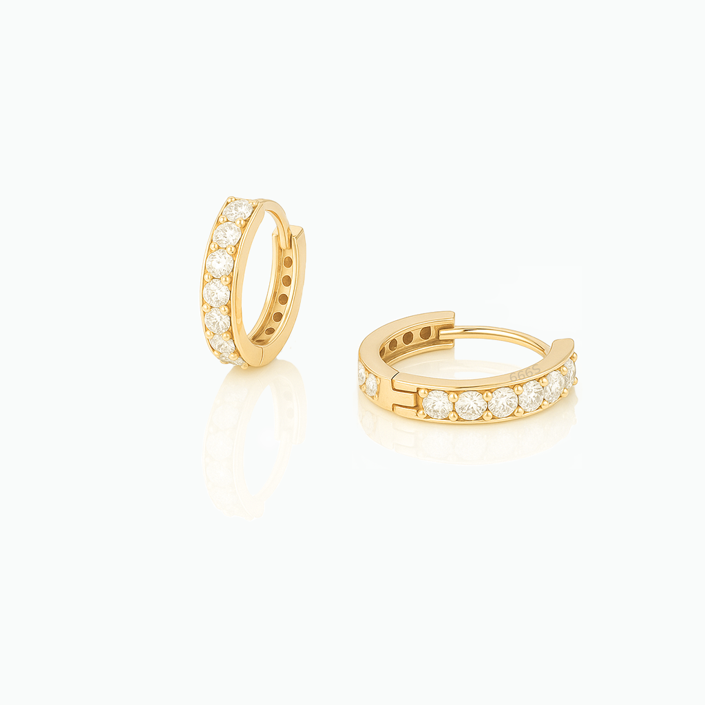Gold hoop earrings with embedded diamonds on a white background