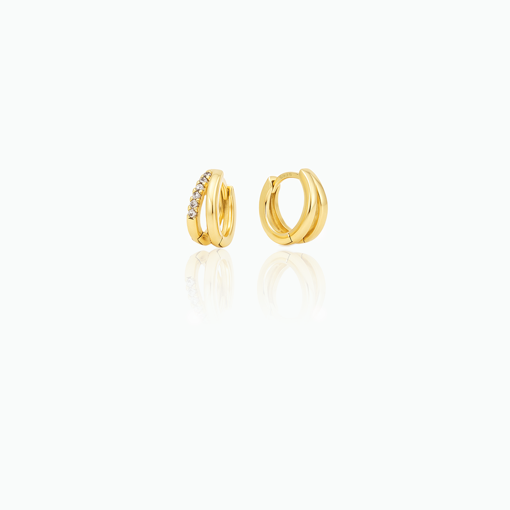 Gold hoop earrings with embedded stones on a white background