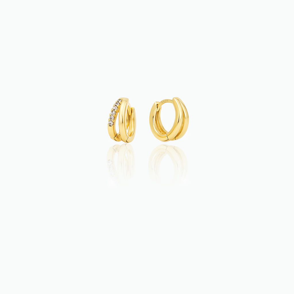 Gold hoop earrings with embedded stones on a white background