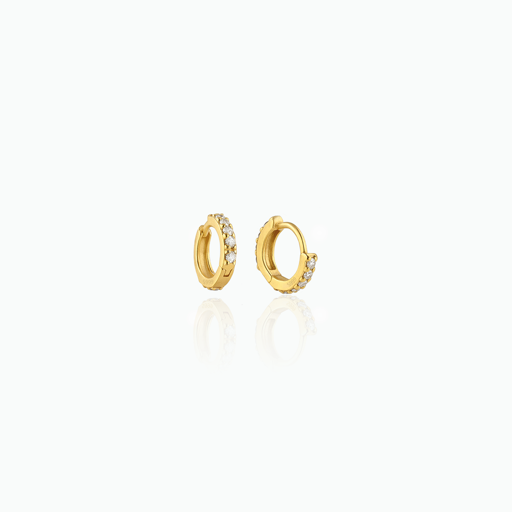Gold hoop earrings with small diamonds on a white background