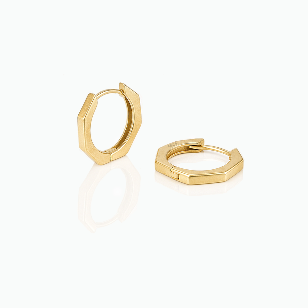 Gold hoop earrings on a white background