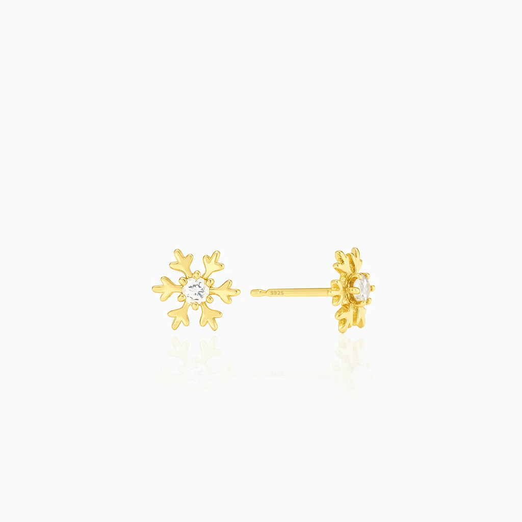 Gold snowflake earrings on a white background