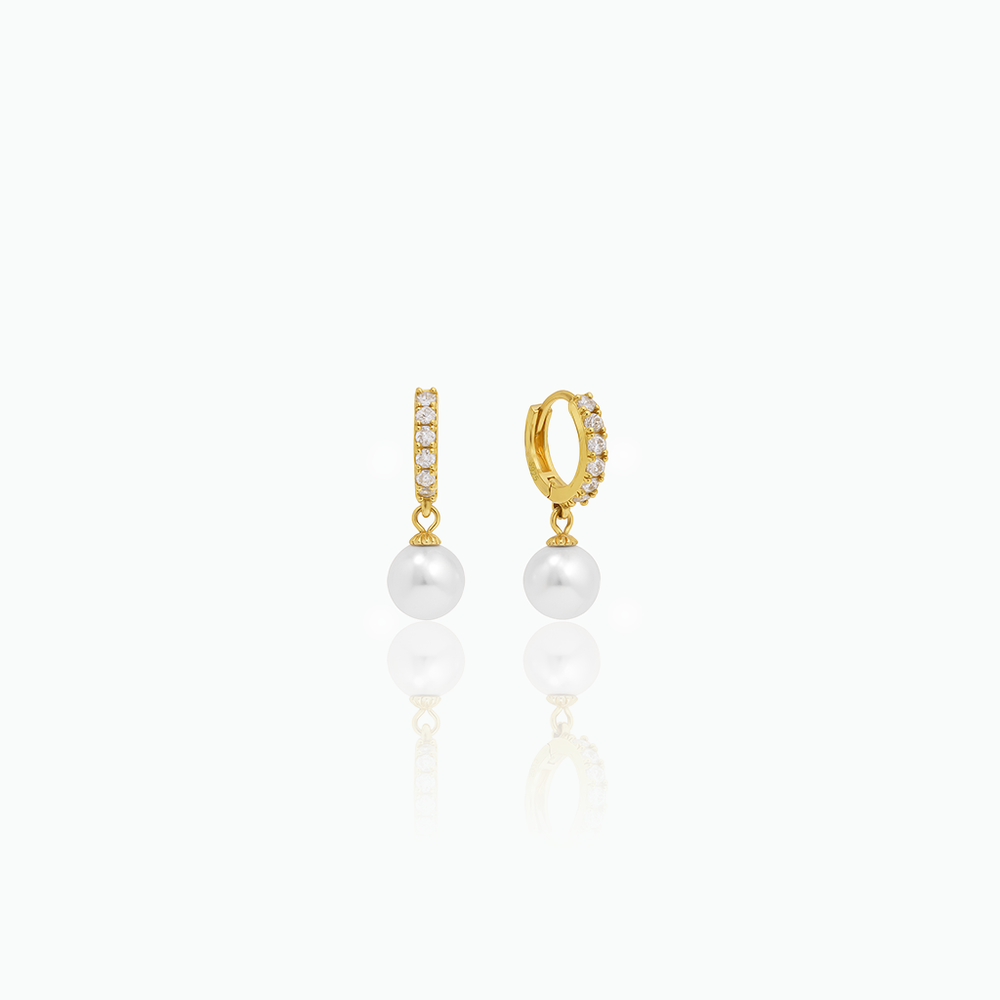Gold hoop earrings with pearl drops on a white background