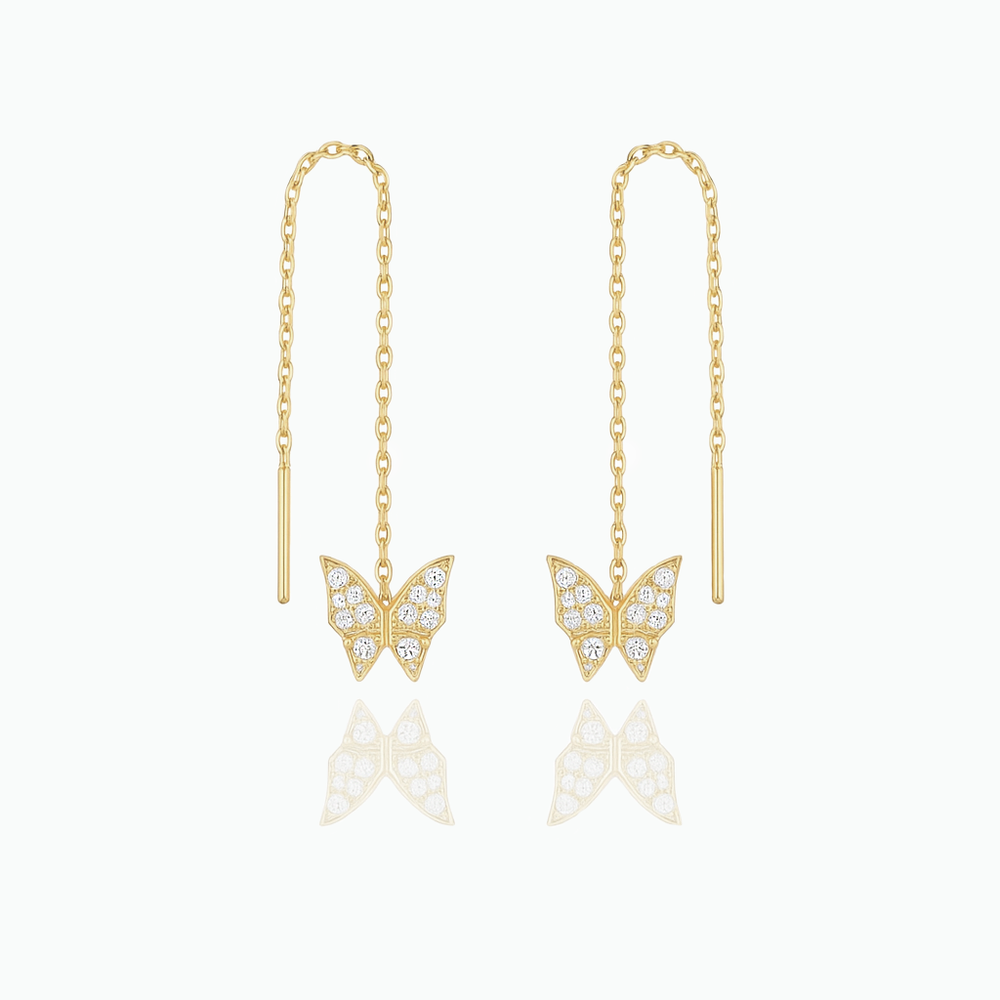 Gold butterfly earrings with chain drops on a white background