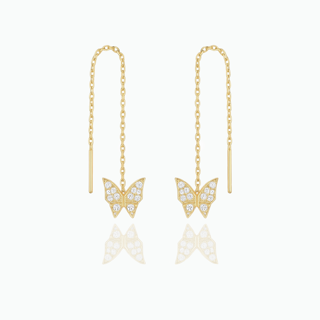 Gold butterfly earrings with chain drops on a white background