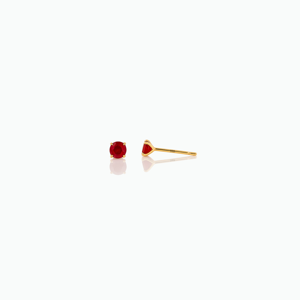 Red gemstone stud earrings on a white background