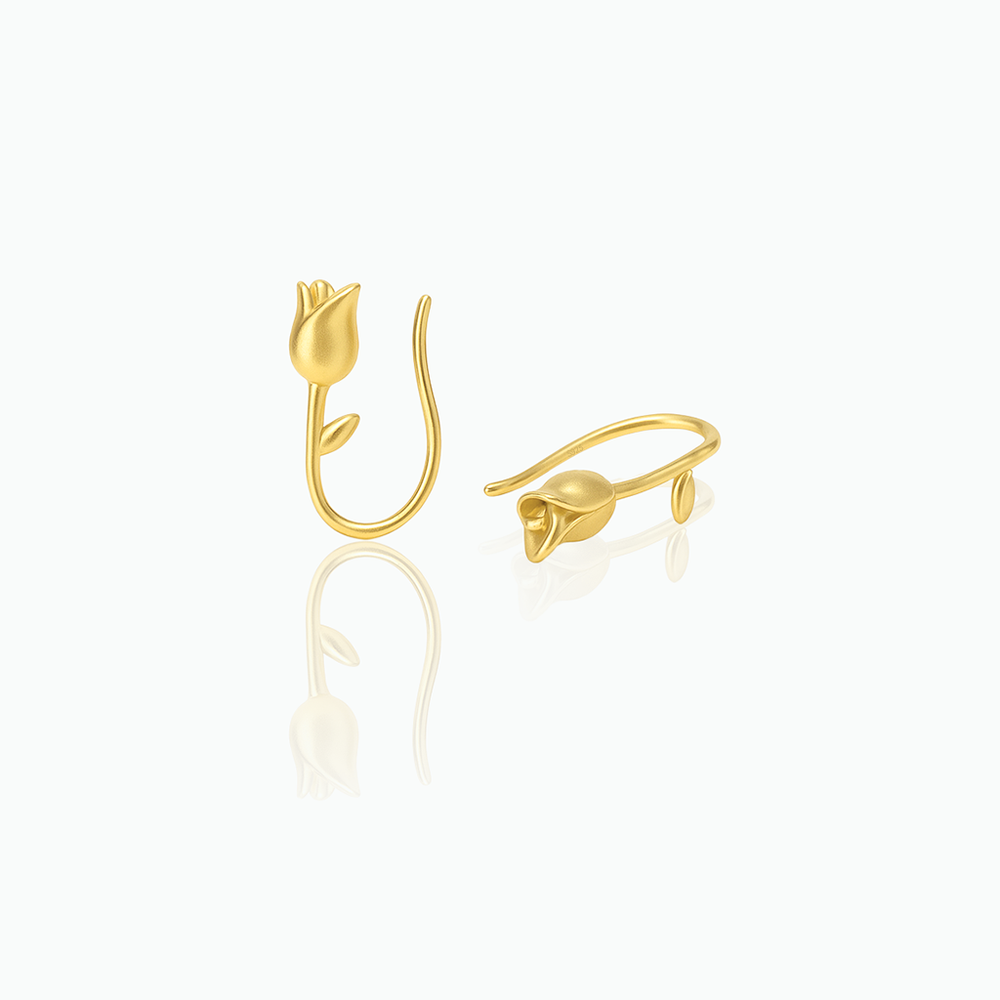 Gold tulip-shaped earrings on a white background