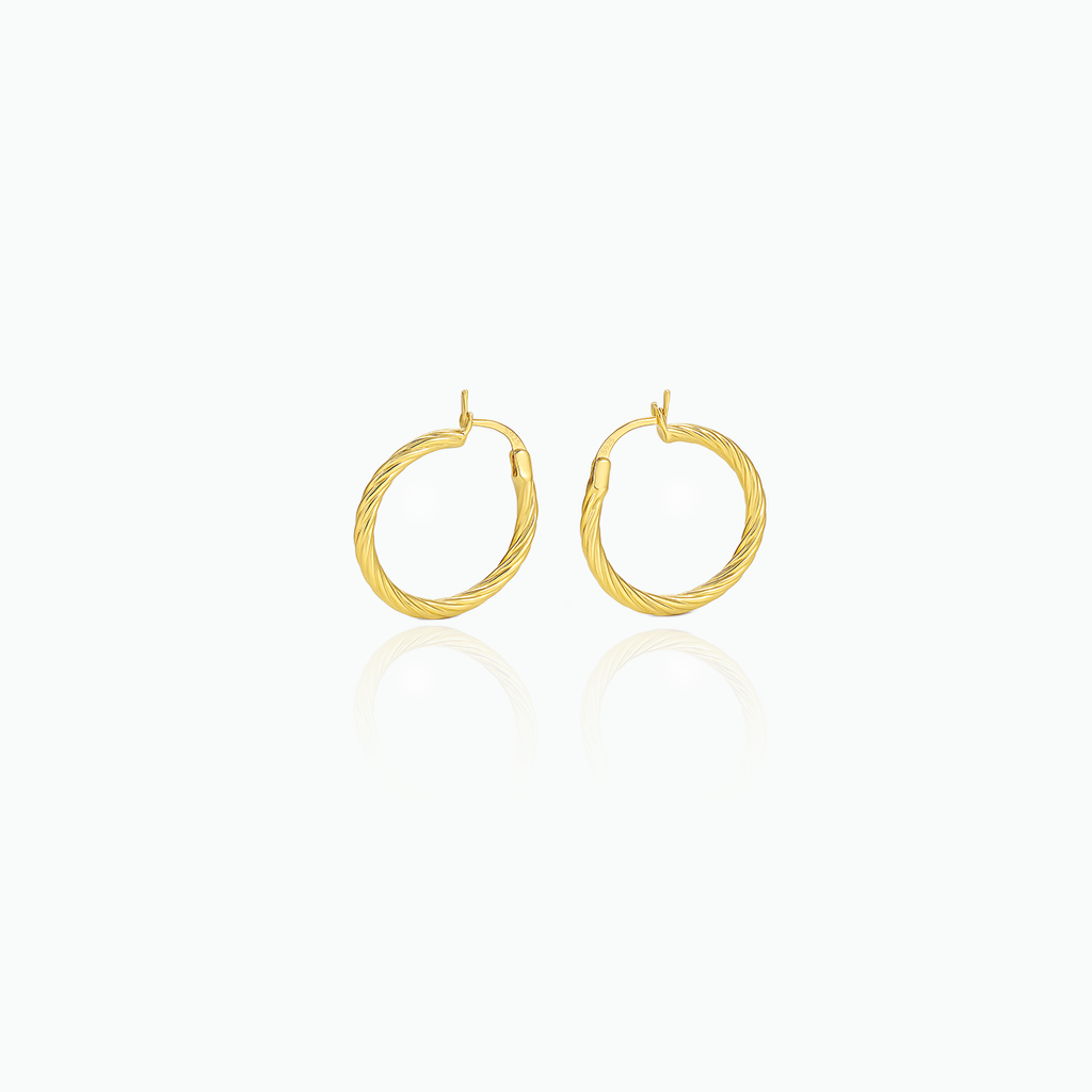Gold hoop earrings on a white background