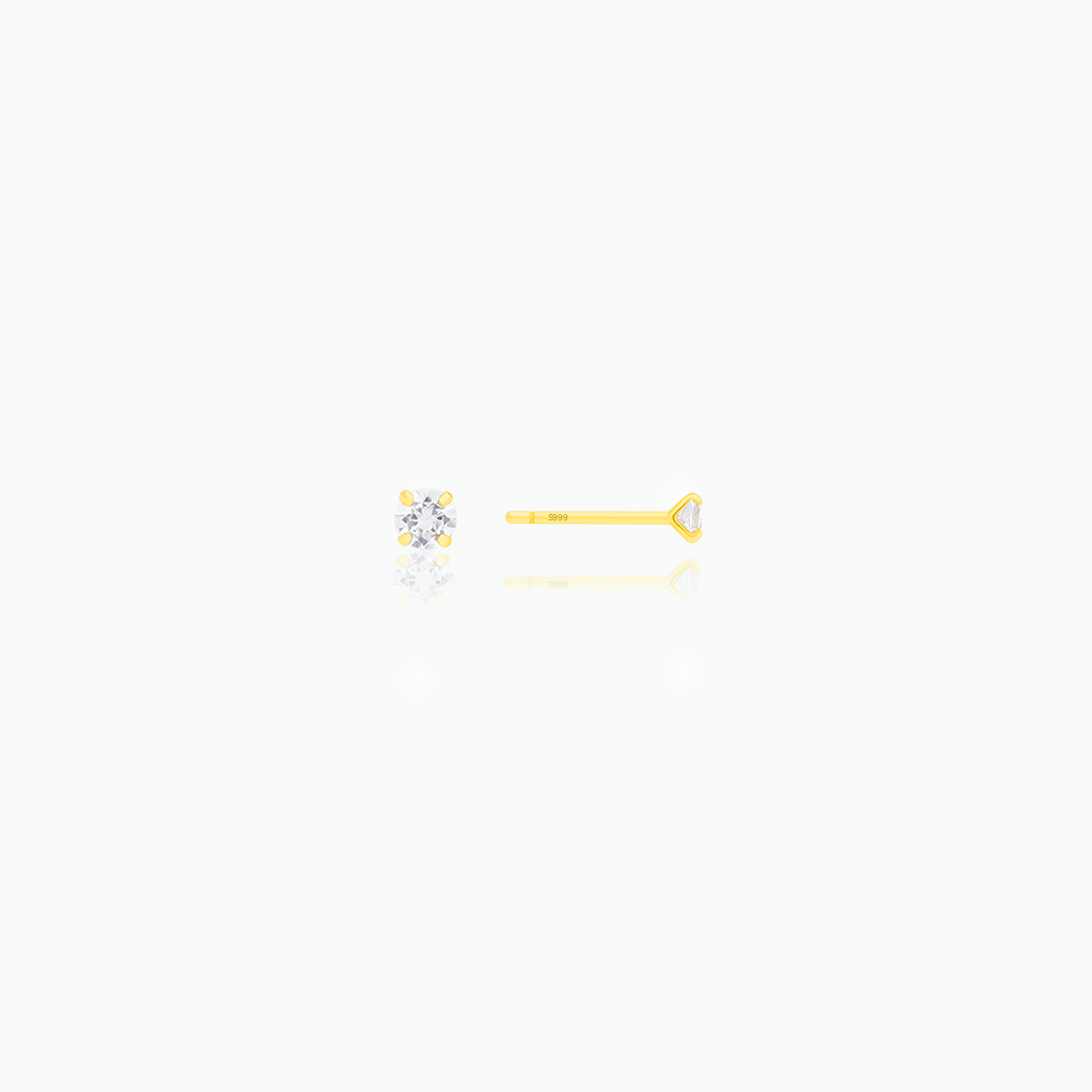 Two stud diamond earrings on a white background