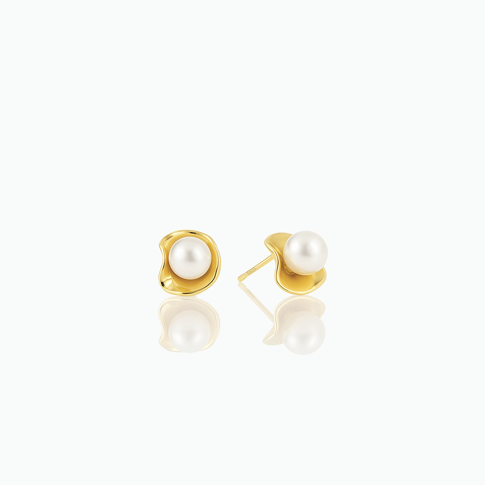 Gold earrings with pearls on a white background