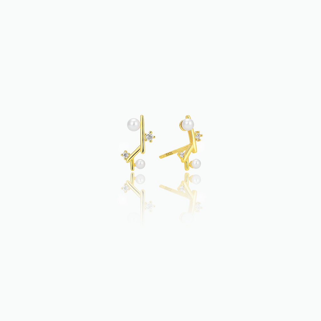 Gold earrings with pearls on a white background