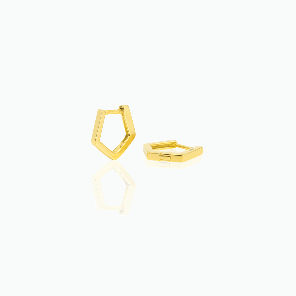Gold geometric huggie hoop earrings on a white background