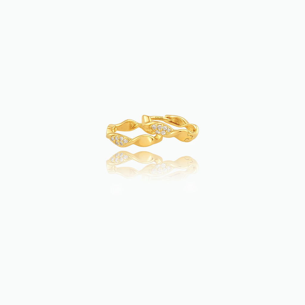 Gold ring with diamond accents on a white background