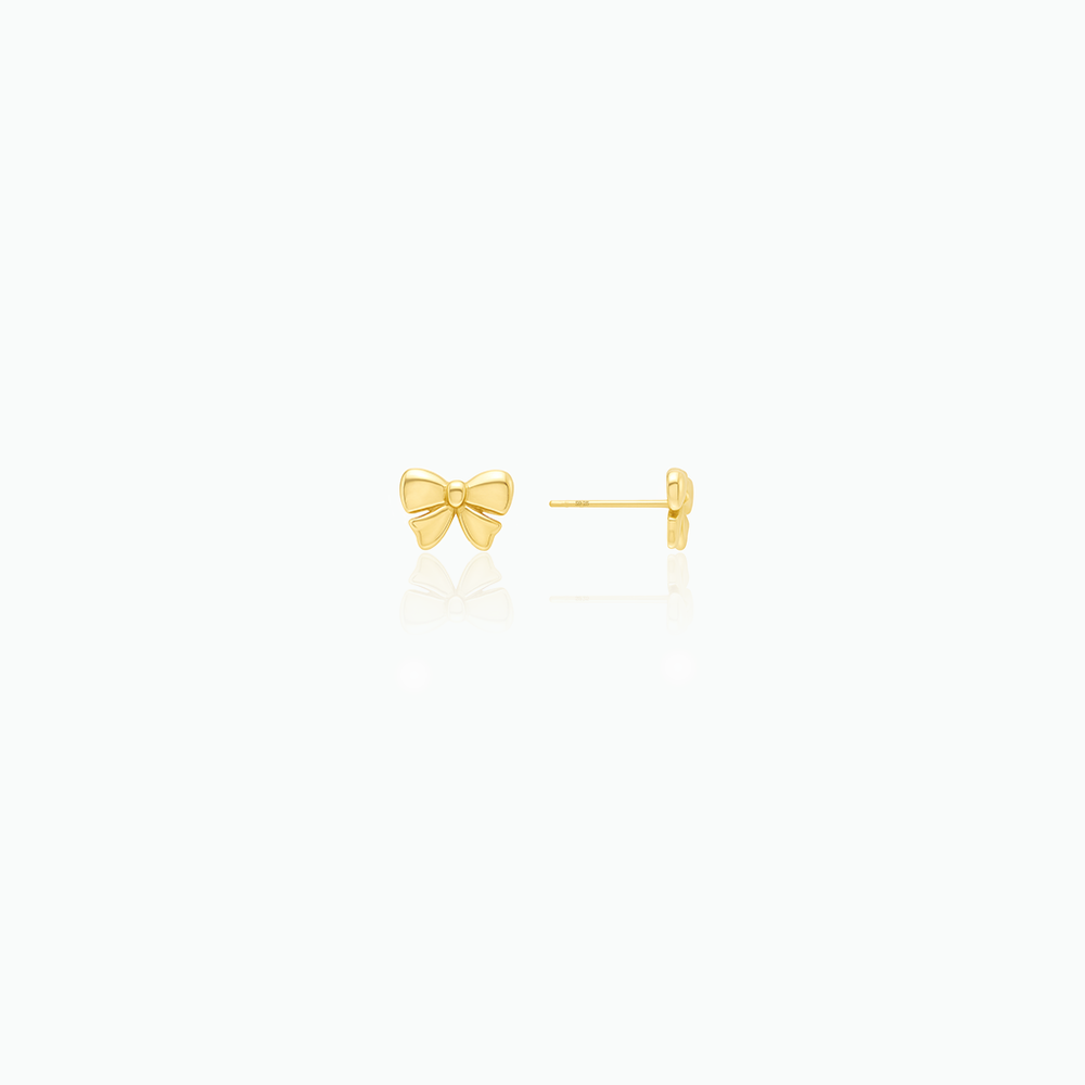 Gold bow-shaped earrings on a white background