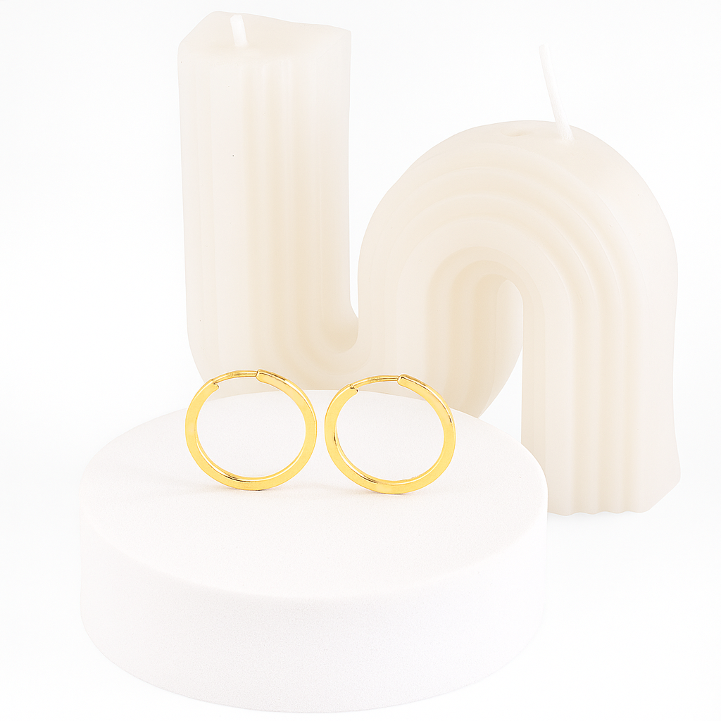 Gold hoop earrings on a white background