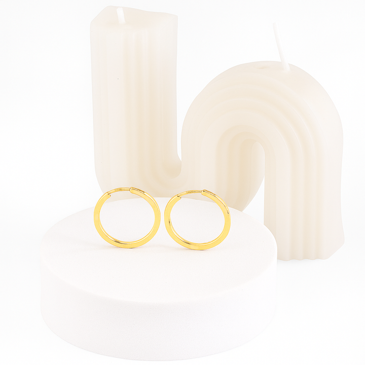 Gold hoop earrings on a white background