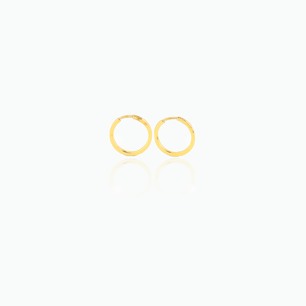 Gold hoop earrings on a white background