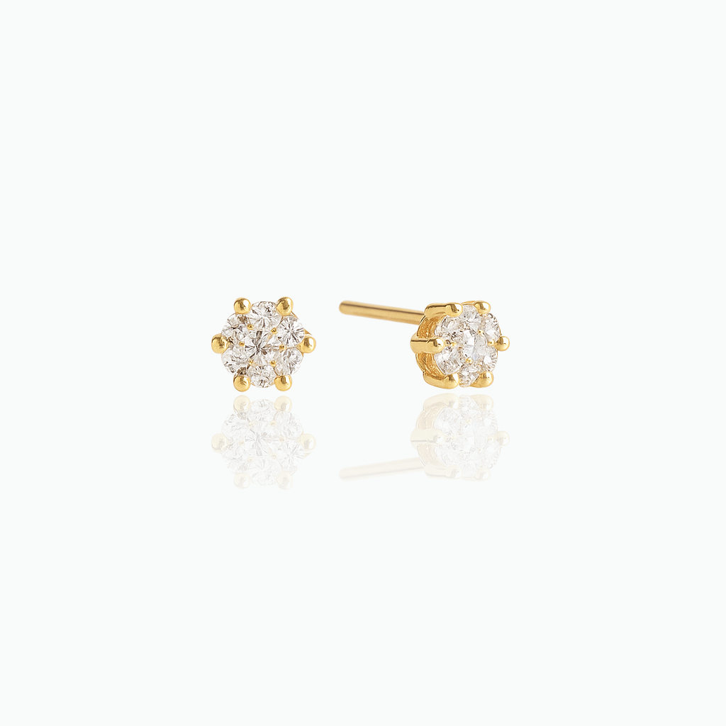 Gold stud earrings with clear gemstones on a white background