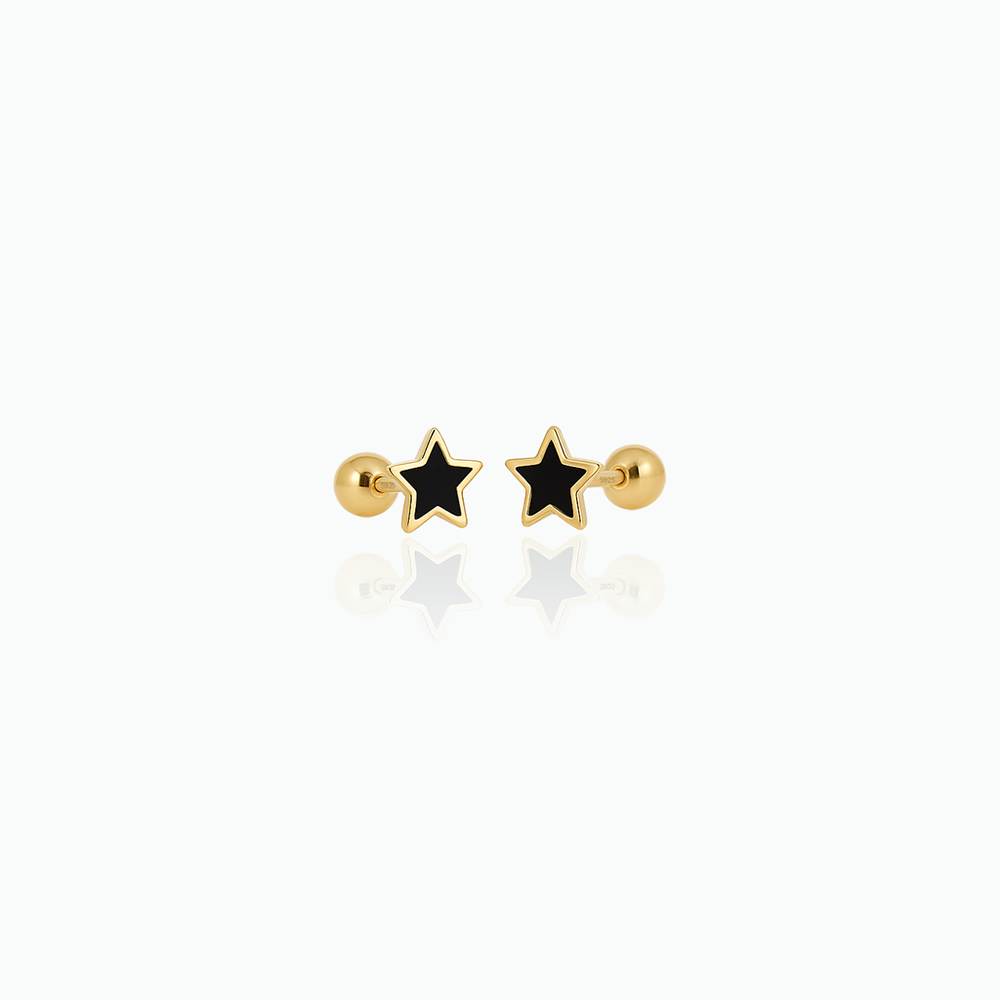 Gold and black star-shaped earrings on a white background