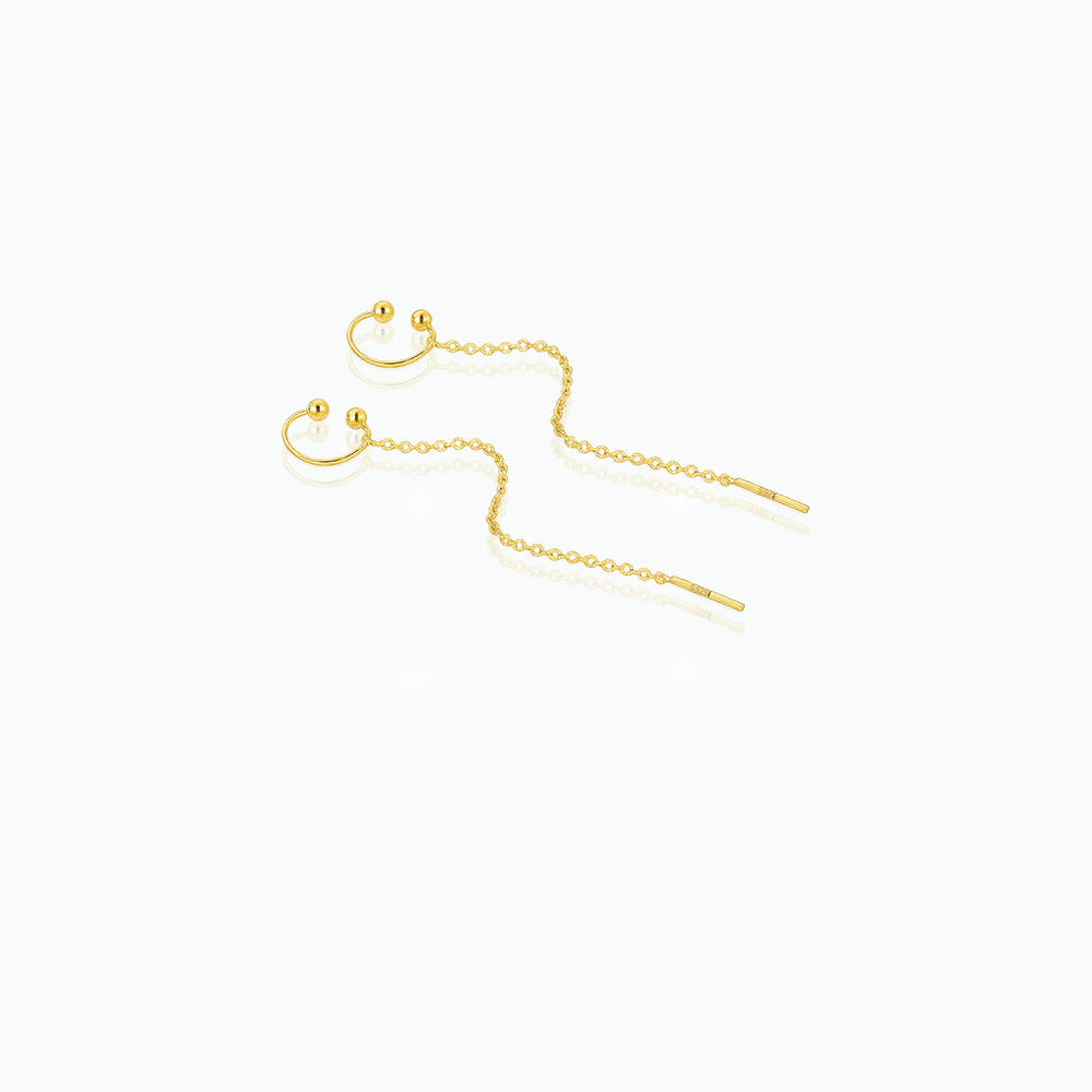 Gold chain earrings on a white background