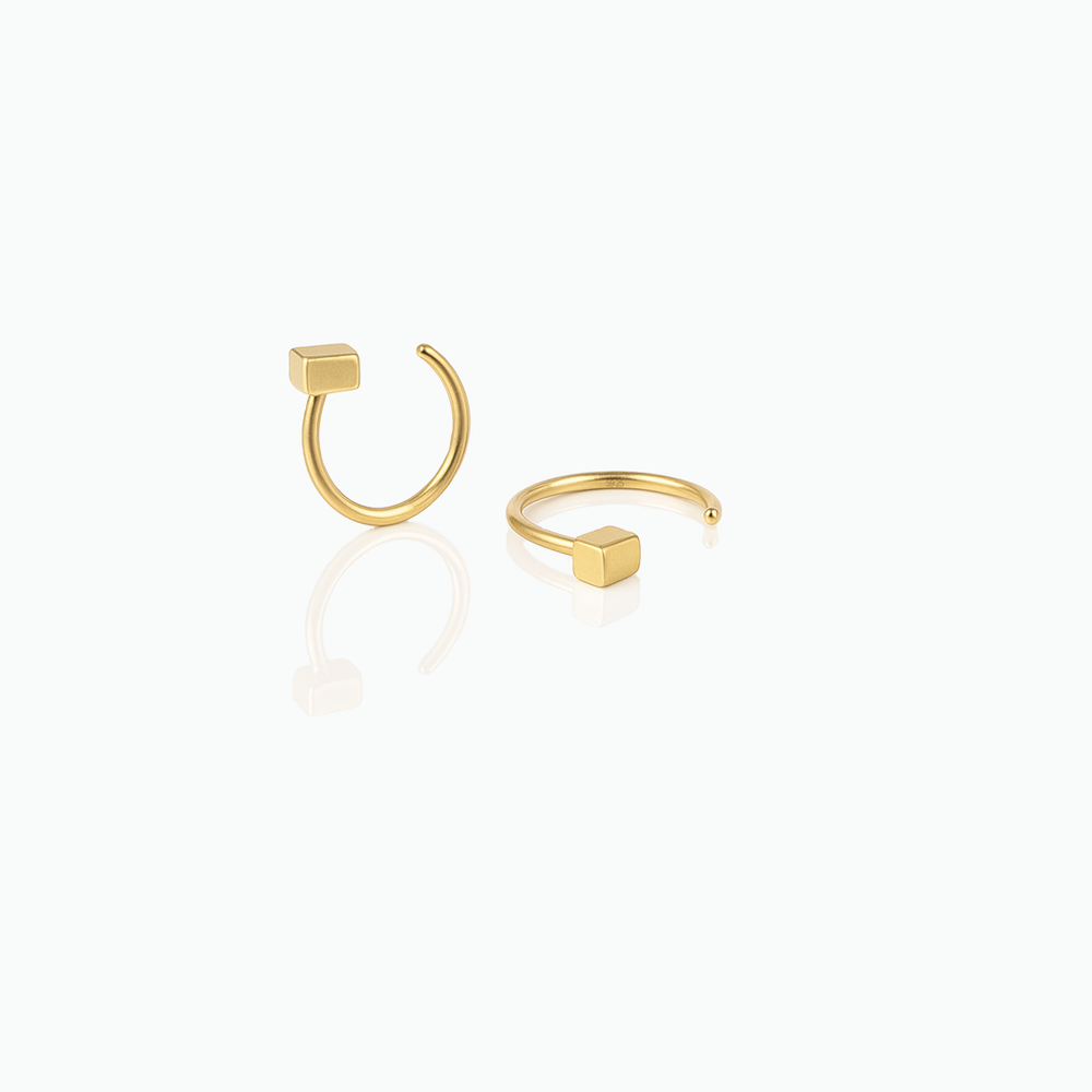 Gold hoop earrings on a white background