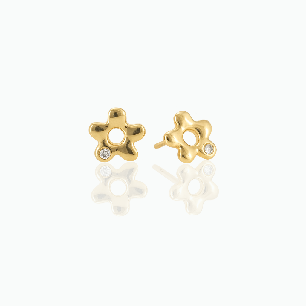 Gold-tone flower stud earrings with clear stone accents displayed on a white background