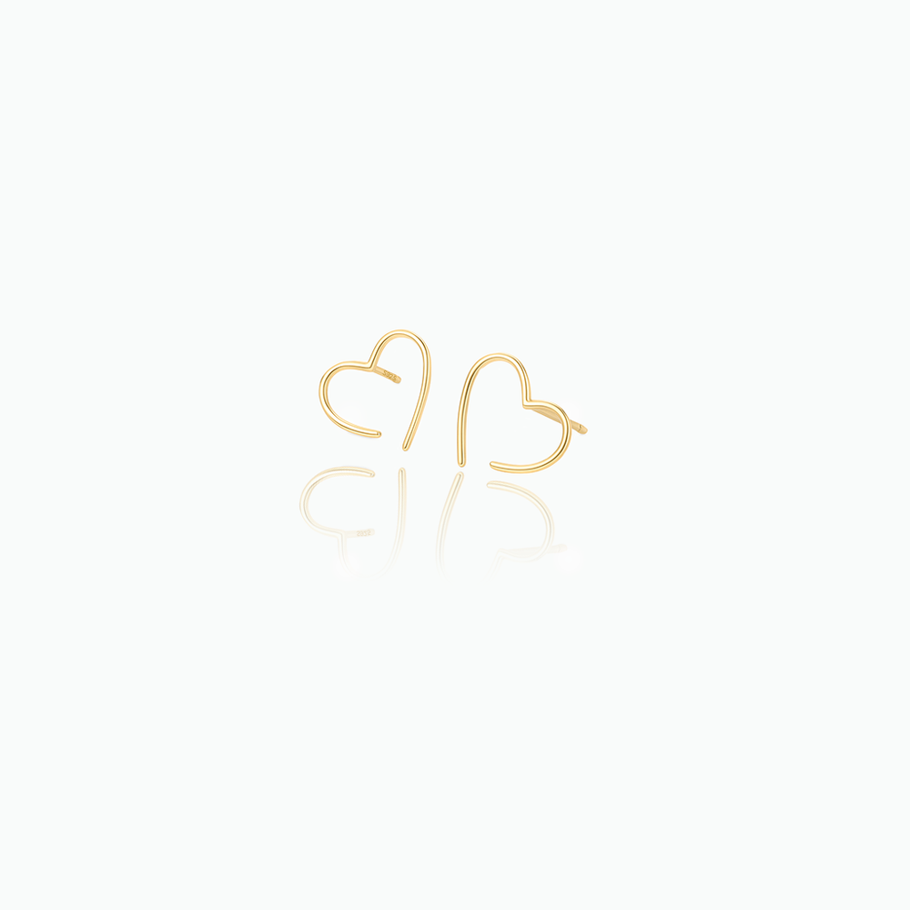 Gold heart-shaped earrings on a white background