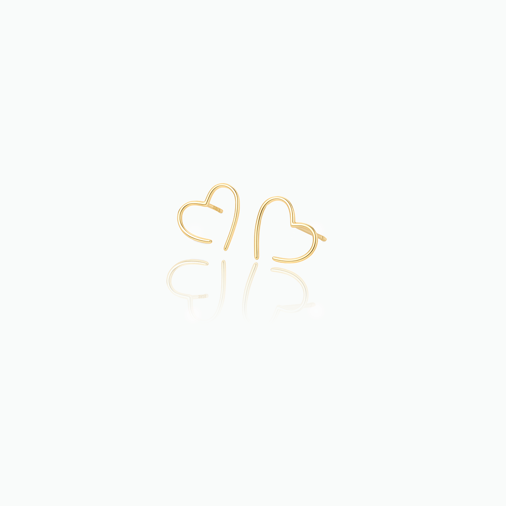 Gold heart-shaped earrings on a white background