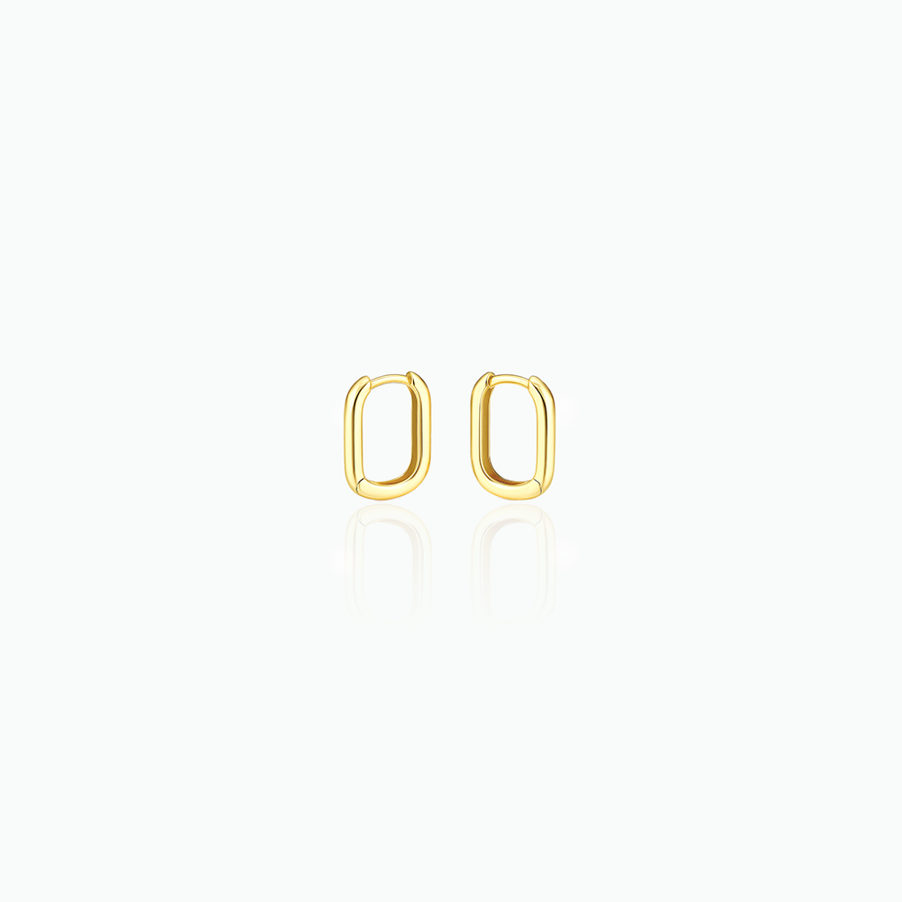 Gold hoop earrings in a white background