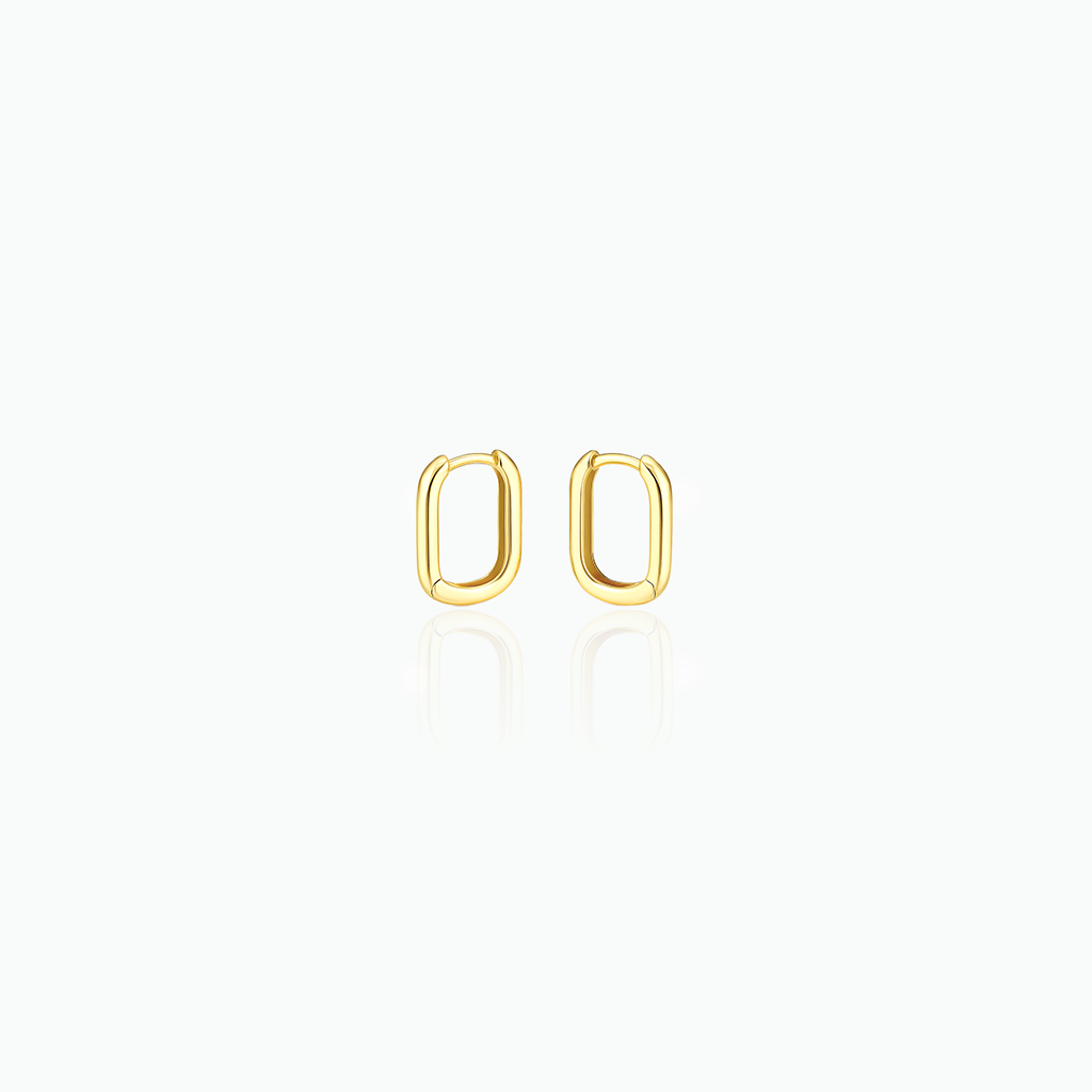Gold hoop earrings in a white background