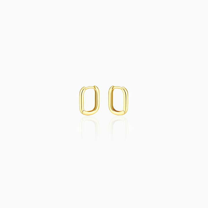 Gold hoop earrings in a white background