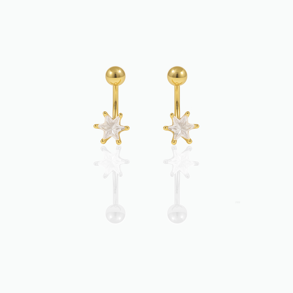 Gold earrings with star-shaped tops on a white background